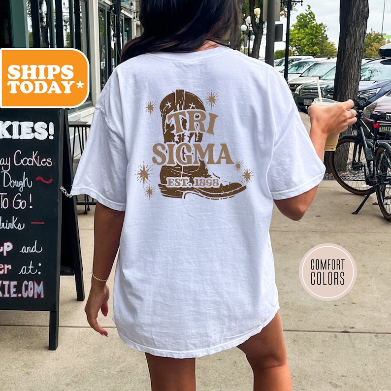a woman walking down a sidewalk holding a cup of coffee