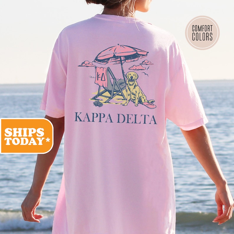 a woman wearing a pink shirt with a picture of a dog under an umbrella