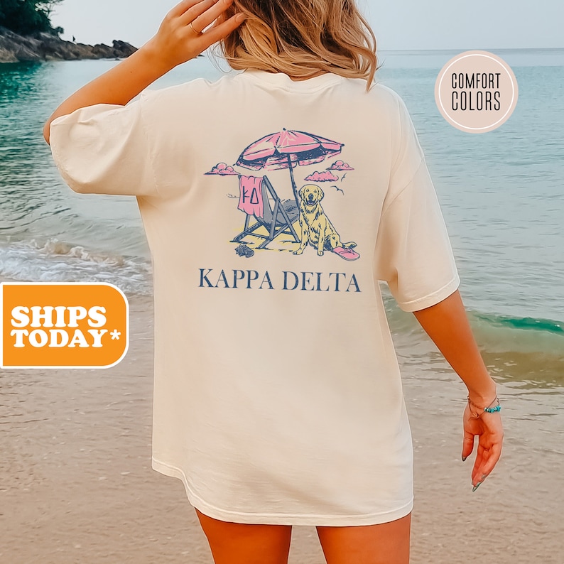 a woman standing on a beach holding an umbrella