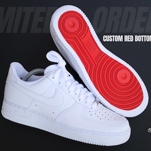 May include: White Air Force 1 sneakers with custom red soles. The shoes are displayed on a black background, with the text "LIMITED ORDERS" and "CUSTOM RED BOTTOM AF1". The design features the Nike swoosh logo.