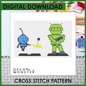 May include: A cross-stitch pattern featuring two pixelated alien figures. One is blue with a smiling face, and the other is green. The words "DIGITAL DOWNLOAD" and "CROSS STITCH PATTERN" are at the top and bottom, respectively. The Deco Monster logo is also visible.