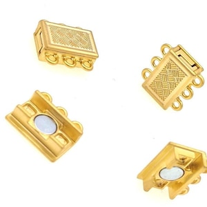 May include: Four gold-toned magnetic clasps for jewellery making. Each clasp has three loops and a textured surface.
