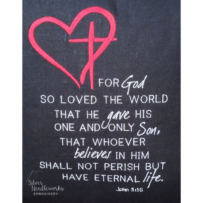 May include: Embroidered design of a red heart with a cross inside, with the text "FOR God SO LOVED THE WORLD THAT HE gave HIS ONE AND ONLY Son, THAT WHOEVER believes IN HIM SHALL NOT PERISH BUT HAVE ETERNAL life. John 3:16" in white.