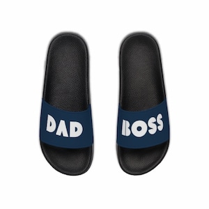 May include: A pair of navy blue slides with white text. The left slide says "DAD" and the right slide says "BOSS".