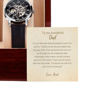 May include: A wooden box with a silver watch and a card inside. The card has a message that reads "To my wonderful Dad. You are the best dad any person could ever ask for. Thank you for always supporting me near & far. Your presence and care as I go through my life endeavors and challenges really makes me the luckiest person in the world. Thank you for being there for the family. You know we will love you forever & always! Love You!"