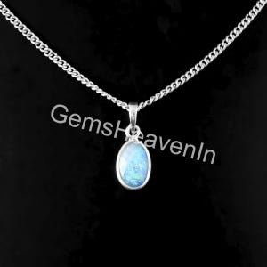 May include: A silver necklace with an oval, light blue opal pendant. The chain is a curb style, and the pendant is set in a silver bezel. The background is black, and the text "GemsHeavenIn" is visible.