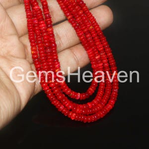 May include: A collection of vibrant red gemstone necklaces. The necklaces are composed of small, round beads, creating a layered effect. The text "GemsHeaven" is visible in the image.