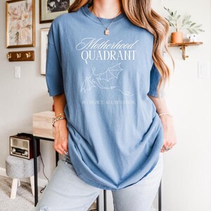 A model wears a comfort to colors shirt in denim blue. It would be great for a mom who loves to read