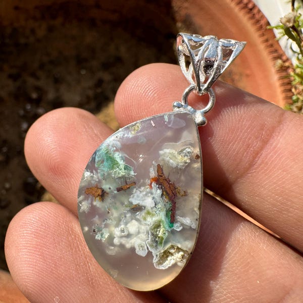 Aquadite pendant featuring copper chrysocolla, gem silica, and copper inclusions with confetti chrysocolla accents in chalcedony.