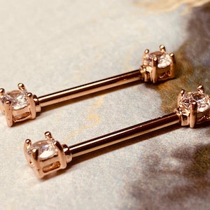 A set of Prong Set Rose Gold Clear Cubic Zirconia Nipple Barbell