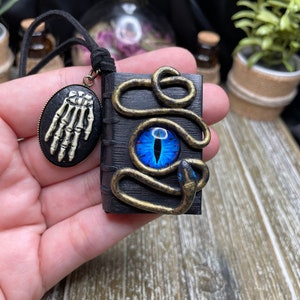 Book of dark spells/Wiccan and Pagan jewelry/Gothic charm with snake eye and a snake figure/Enchanted gift for witches, wizards, bookworms