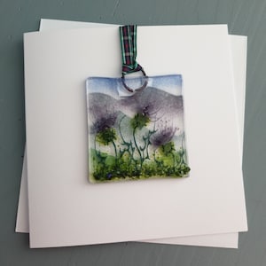 A "Wee Mindin" card and detachable Scottish Thistle hanging