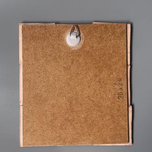 May include: A square wooden backing board with a light brown textured surface, featuring a central white plastic wall mount with a metal triangular hanger. The board has the text 20x20 stamped on the right side, indicating its dimensions.