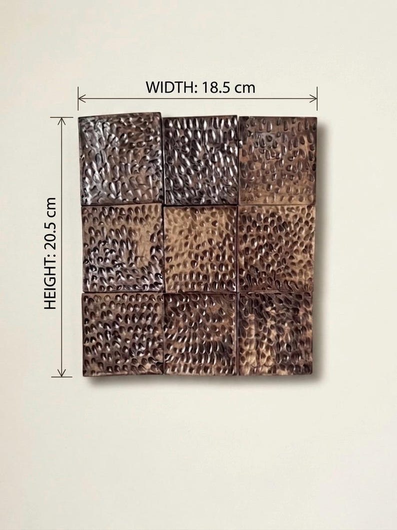May include: A square grid of nine dark brown tiles with a hammered, textured surface. The tiles are arranged in a three-by-three pattern. The overall dimensions are indicated as 18.5 cm in width and 20.5 cm in height, as shown by the measurement lines.