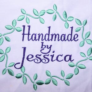 May include: Embroidered design on a white background. The text "Handmade by Jessica" is in purple script, surrounded by a green leaf and vine border. The design is likely for a craft or handmade item.