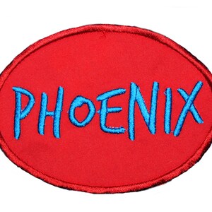 May include: Red oval-shaped patch with the word "PHOENIX" embroidered in blue.