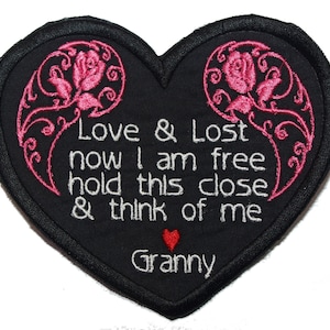 May include: Black heart-shaped patch with pink embroidered roses and the text "Love & Lost now I am free hold this close & think of me Granny".