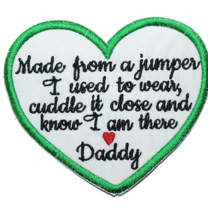 May include: Green heart-shaped patch with a white background and black embroidered text that reads "Made from a jumper I used to wear, cuddle it close and know I am there Daddy". A small red heart is embroidered below the text.