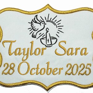 May include: White embroidered patch with gold trim, displaying the names "Taylor Sara" and the date "28 October 2025". A dove, candle, and sunburst design is in black. The patch has a decorative, scalloped edge.