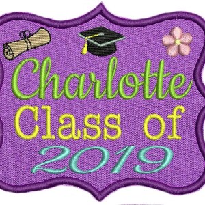 May include: Purple graduation patch with a green and yellow embroidered design. The patch features a graduation cap, a scroll, a flower, and the text "Charlotte Class of 2019".
