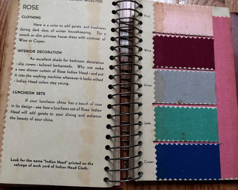 May include: A page from a color selector book showing fabric swatches in shades of pink, burgundy, gray, teal, and blue. The page is titled "Rose" and includes text about using the color for clothing, interior decoration, and luncheon sets.