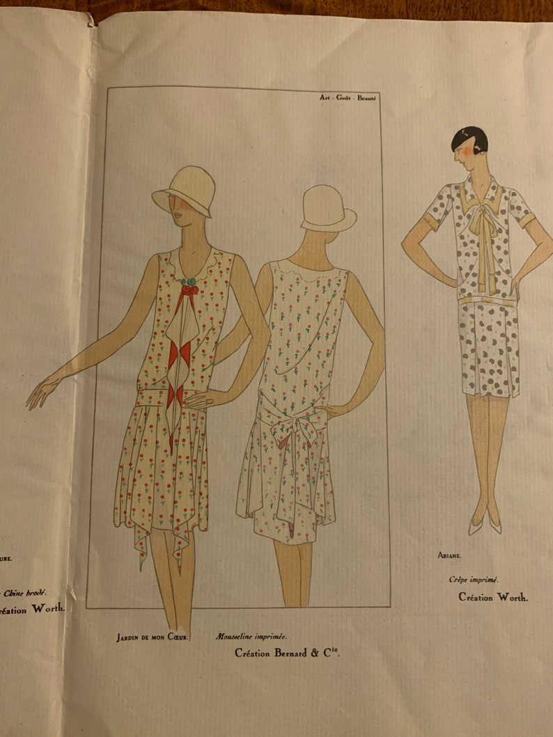 May include: A fashion illustration from a vintage magazine featuring three women wearing dresses. The dresses are all different styles and have floral prints. The text on the page reads "Jardin de mon Coeur", "Mousseline imprim&eacute;e. Cr&eacute;ation Bernard & Cie", "Ariane", and "Cr&ecirc;pe imprim&eacute;. Cr&eacute;ation Worth."