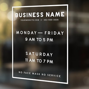 May include: A rectangular white vinyl window decal featuring the text BUSINESS NAME, YOURWEBSITE.COM, 353-555-3535, MONDAY-FRIDAY 9 AM TO 5 PM, SATURDAY 11 AM TO 7 PM, and NO FACE MASK NO SERVICE, all enclosed within a thin white rectangular border.