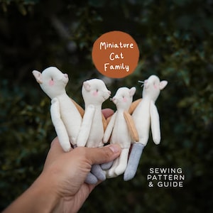 May include: Four small, off-white fabric cat dolls with pink cheeks and tan or grey accents. A brown circular graphic features the text Miniature Cat Family, and the bottom right corner includes the text SEWING PATTERN & GUIDE.