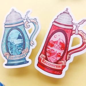 May include: Two sticker designs of decorative beer steins. One is light blue with "Nicobranas" on a banner, the other is red with "Rexxentrum" on a banner. Each stein features a detailed landscape scene within its oval center.