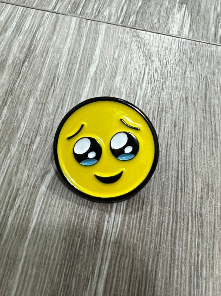 Teary eyed emoji enamel pin / face holding back tears emoji enamel pin