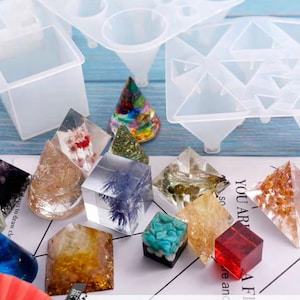 May include: A clear silicone mould with multiple pyramid and cone shapes. The mould is shown with various resin castings, including clear resin with dried flowers, glitter, and turquoise stones.