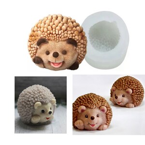 May include: A silicone mould for making hedgehog-shaped cakes or other treats. The mould is white and has a detailed hedgehog design. The image also shows two finished hedgehogs made with the mould, one brown and one grey.