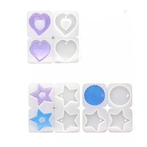 May include: A set of silicone moulds for making resin jewellery. The moulds are in the shape of hearts, stars and circles. The moulds are shown with resin pieces in them, which are purple, blue and clear.