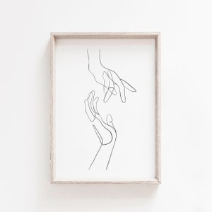 May include: A black and white line drawing of two hands reaching towards each other.