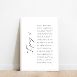 May include: A white framed print with a black and white design. The print features a handwritten "I pray" in cursive script and a passage from Ephesians 3:16-21 about the love of Christ.