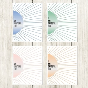 May include: Set of four printable cards with a sunburst design and the text "I am grateful for" in a circle. The cards are in blue, green, pink, and orange.