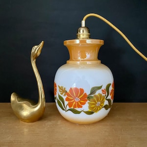 Lámpara vintage de globo en opalina blanca y perlada con diseños florales.