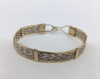 A braided wire bracelet with sterling silver and gold filled wire