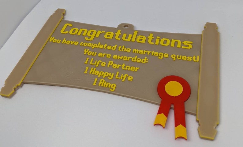 May include: A tan, scroll-shaped plaque with yellow pixelated text reading: Congratulations, You have completed the marriage quest! You are awarded: 1 Life Partner, 1 Happy Life, 1 Ring. A red and yellow ribbon seal is attached to the bottom right.
