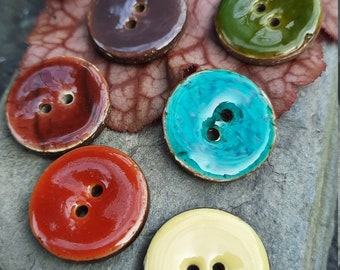 Boutons brillants 23 mm en noix de coco. 6 couleurs et 3 boutons par paquet.