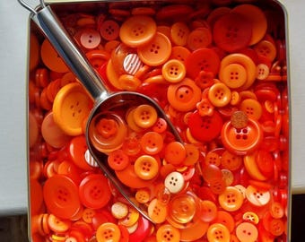 Mixed 50g bag of Orange buttons