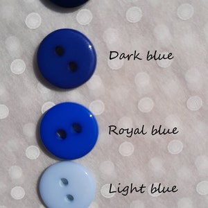 May include: Five round buttons in different shades of blue, from dark navy to light aqua. The buttons are arranged vertically, with the darkest blue at the top and the lightest blue at the bottom. The text below each button describes the shade of blue: Navy blue, Dark blue, Royal blue, Light blue, Aqua blue.