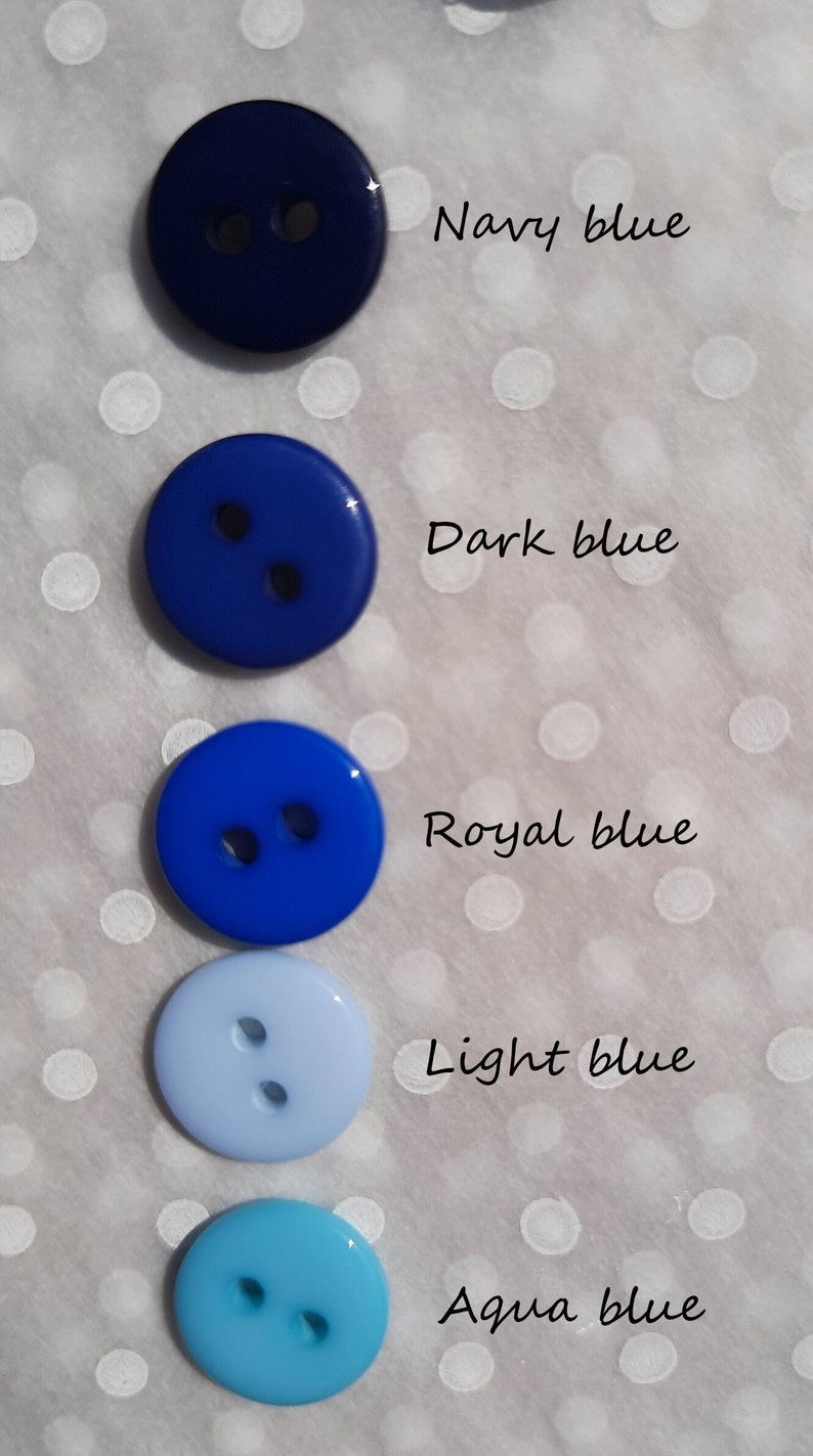 May include: Five round buttons in different shades of blue, from dark navy to light aqua. The buttons are arranged vertically, with the darkest blue at the top and the lightest blue at the bottom. The text below each button describes the shade of blue: Navy blue, Dark blue, Royal blue, Light blue, Aqua blue.