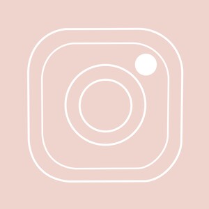 May include: A white outline of a camera icon on a light pink background. The camera icon has a circle inside of a square with a smaller circle inside the larger circle.