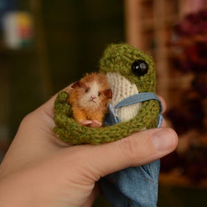 Handmade Knitted Frog Plushie with Mini Pet, Knitted frog with overalls and shoes, and a guinea pig.
