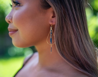 Hand painted genuine leather turquoise earrings with gold teardrop shaped hoops.