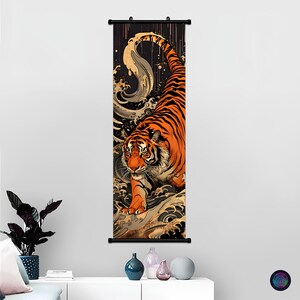 May include: A vertical wall hanging featuring a tiger with orange and black stripes, depicted in a dynamic pose amidst stylized swirling water waves. The artwork is framed by black horizontal bars at the top and bottom, creating a scroll-like display.
