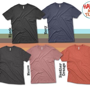 three different colors of t - shirts with a happy as i travel sticker on