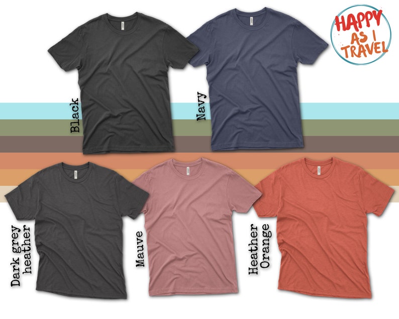 three different colors of t - shirts with a happy as i travel sticker on