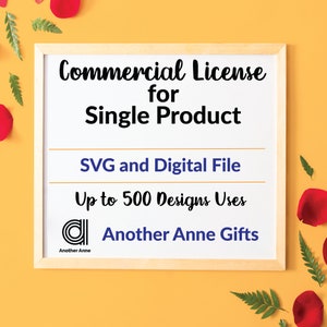 May include: A white framed sign with the text "Commercial License for Single Product" in black. Below the text is "SVG and Digital File" in blue and "Up to 500 Designs Uses" in black. The sign also includes a logo with the text "Another Anne Gifts" in blue.